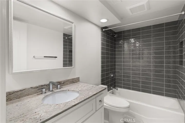 The newly remodeled secondary bathroom features a shower/tub combo