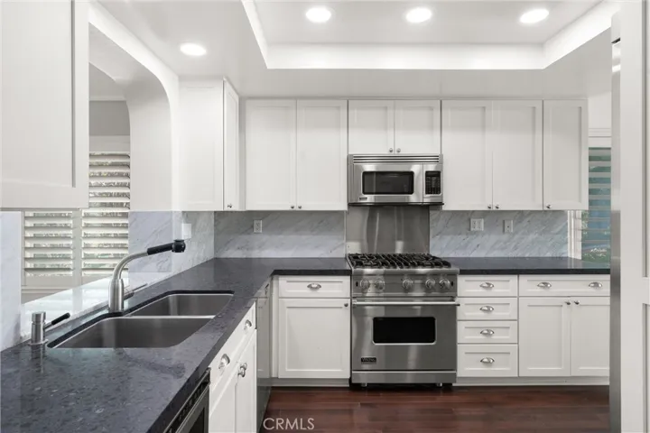 The kitchen features stainless steel Viking and Miele appliances