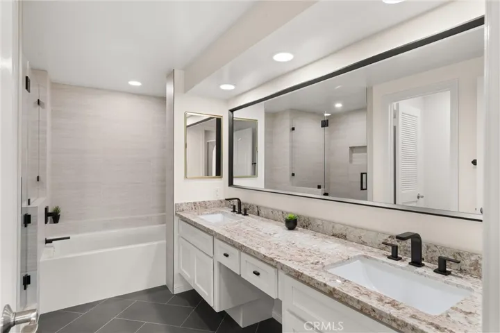 The primary suite features a newly remodeled bathroom including dual vanity, soaking tub, and walk-in shower.