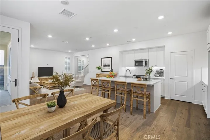 Rendering of possible furnishing of dining, kitchen bar and living room.