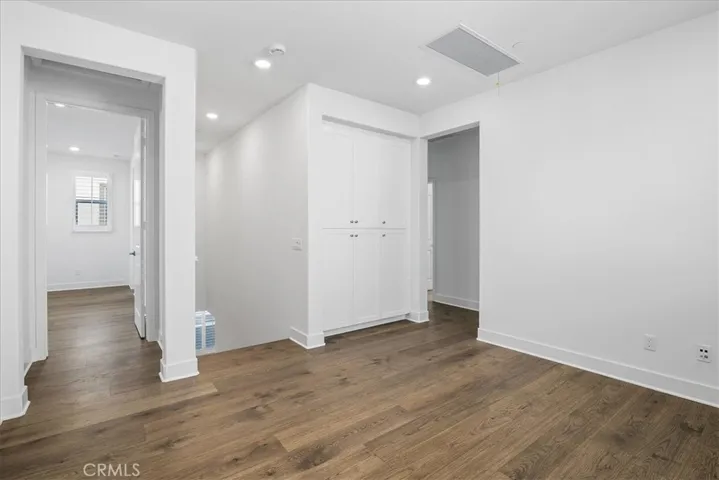 View of loft to stairs and to left entry to primary bedroom suite.