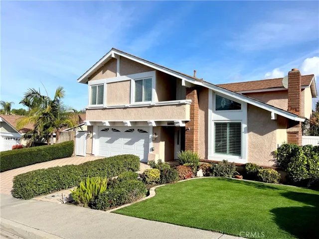 Spectacular front yard with turf grass, well manicured landscaping and gorgeous vinyl fencing!