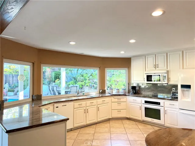 Sprawling kitchen overlooking gorgeous entertainment backyard!