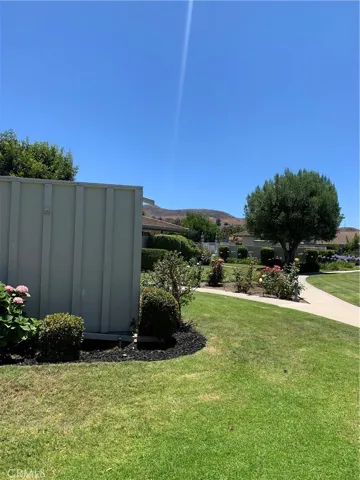side of home - lots of greenspace and close to pool