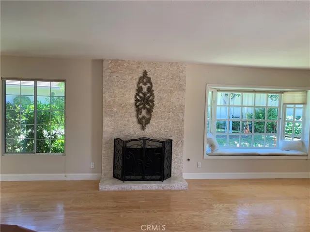 Hardwood floors, stone fireplace, bay window