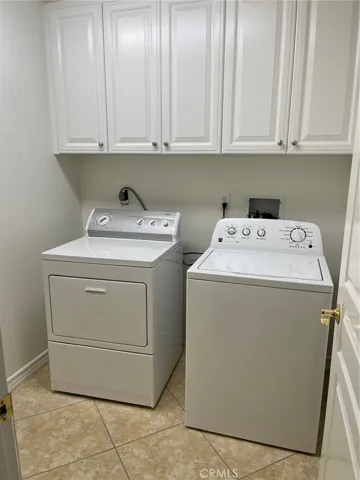 Separate laundry room on downstairs/entry level between attached garage and downstairs suite