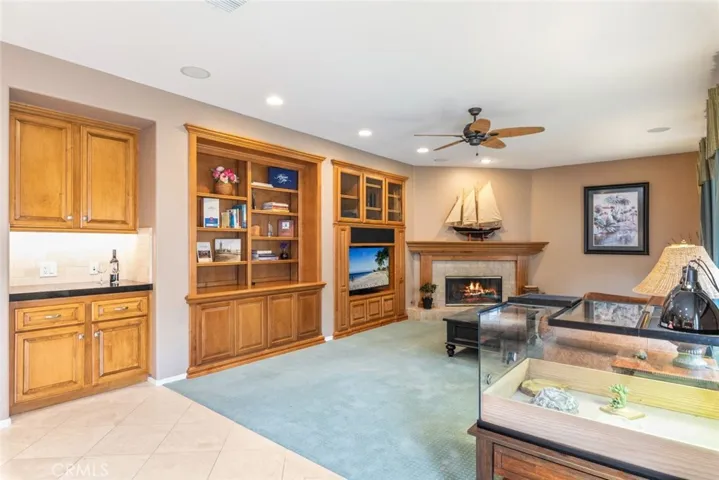 A comfy family room, with built-in cabinetry and cozy fireplace, illustrates a perfect setting for home comfort.