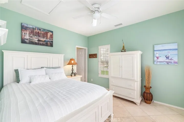 Light and space abound in a tranquil bedroom that seamlessly blends comfort with access to the sun-kissed outdoors.