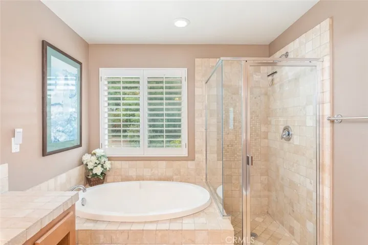 
A serene oasis awaits with this upgraded bathroom’s luxurious soaking tub, perfect for unwinding in a stylish and tranquil setting.