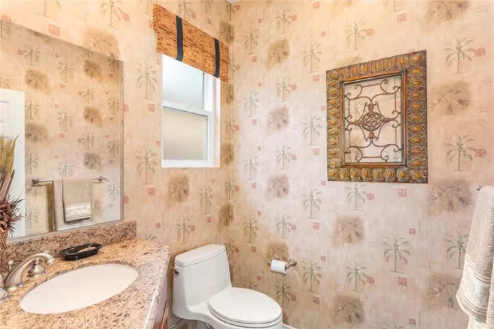 An elegantly wallpapered bathroom with a shower, evoking a tropical​​‌​​​​‌​​‌‌​​‌​​​‌‌​​​‌​​‌‌​​‌‌​​‌‌​​​​ vibe.