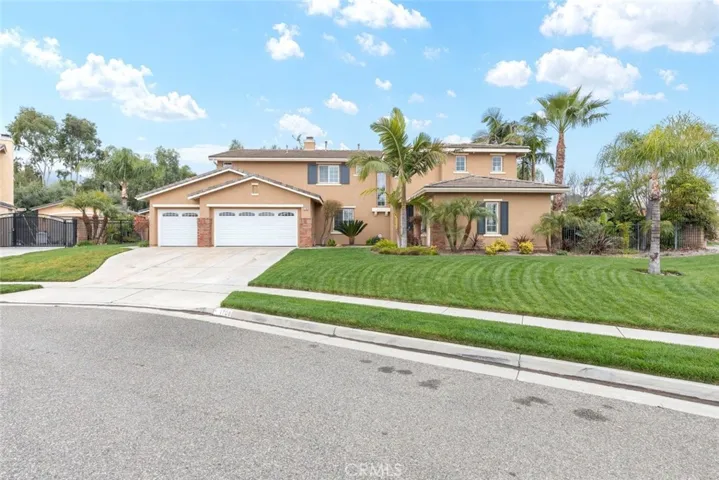 Another angle of the inviting corner home showcases its expansive driveway and beautifully maintained front yard..