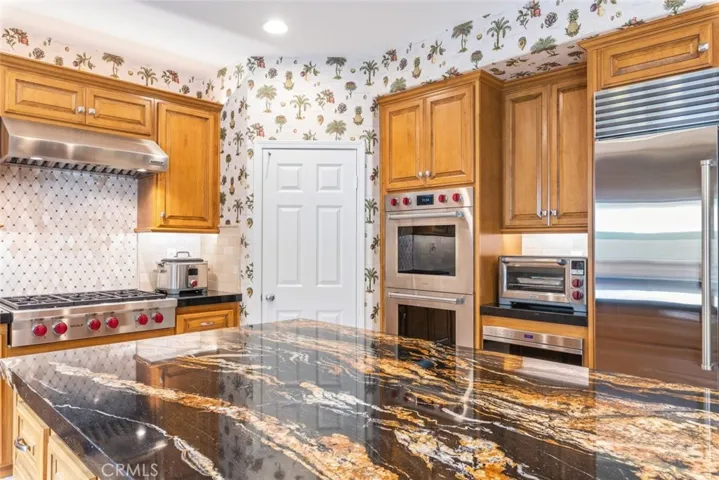 The spacious kitchen is a home chef's delight with state-of-the-art appliances and ample room for dining and entertaining.