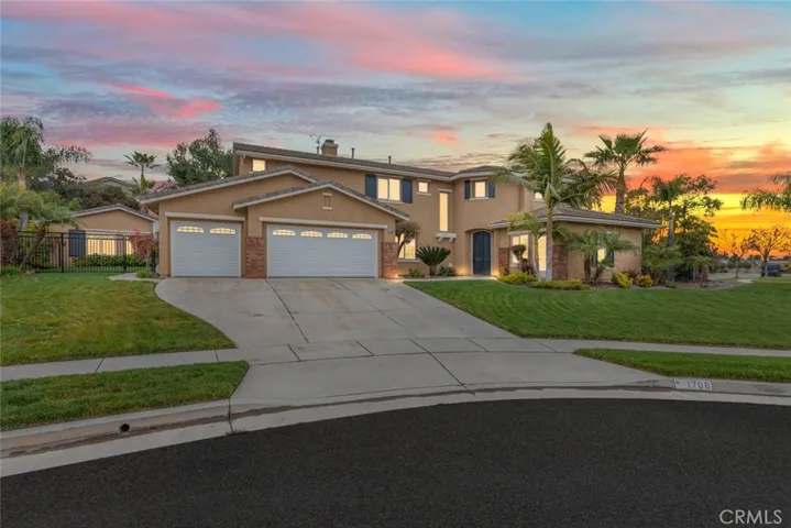 A welcoming suburban home graces the corner with manicured lawns and towering palm trees under a serene sky.