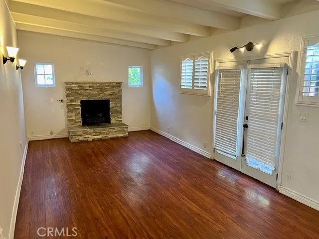 Step-down Family Room with laminate flooring and ceiling beams