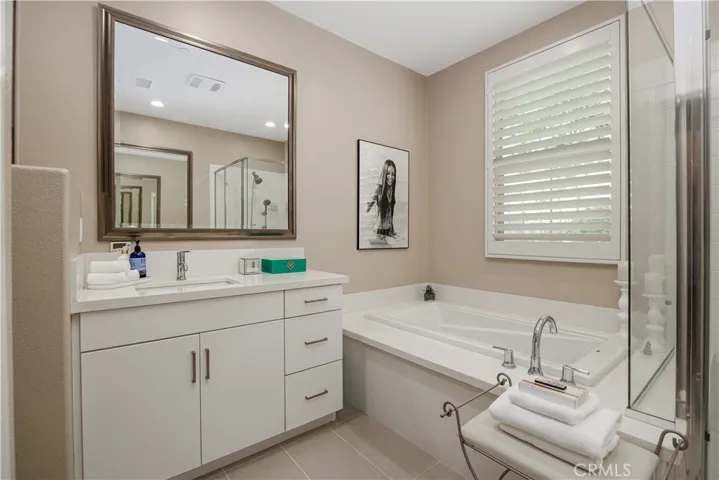 Separate primary quartz vanities.  Tub with custom quartz surround.