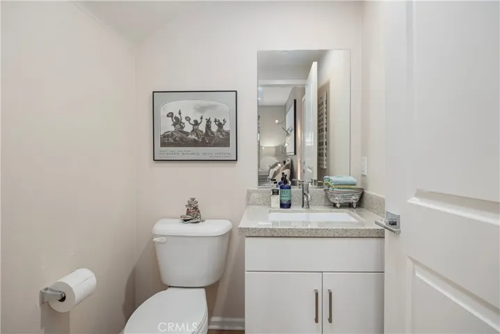 Main level bathroom with quartz countertop.