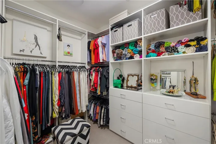 Primary bedroom closet with custom built-ins.
