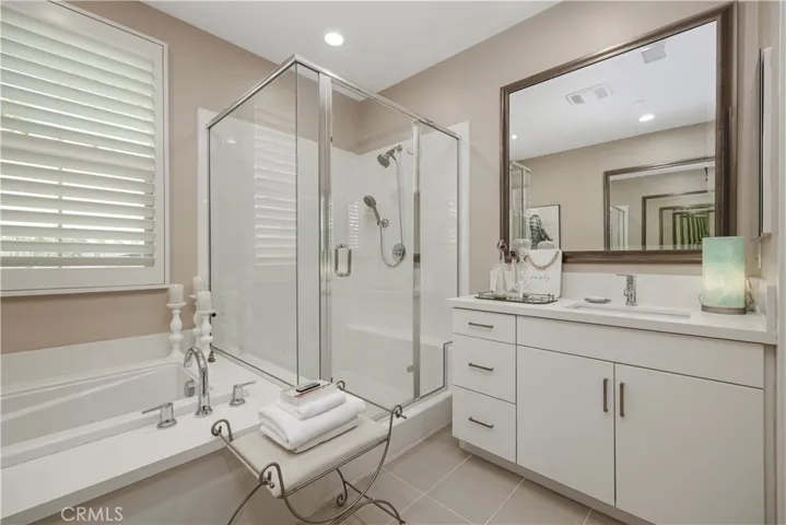 Primary bathroom with tub and separate shower.
