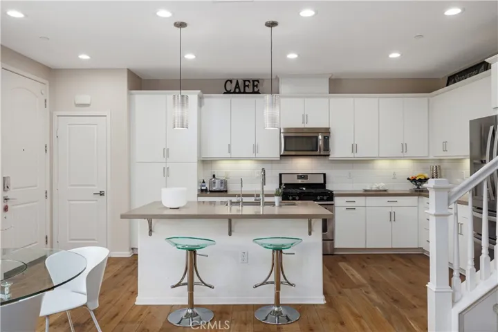 Upgraded white kitchen cabinets with tile backsplash,  Kohler stainless steel farmers sink. Quartz countertops and custom pendant lighting.  Hardwood Oak Nantucket flooring throughout the main level.