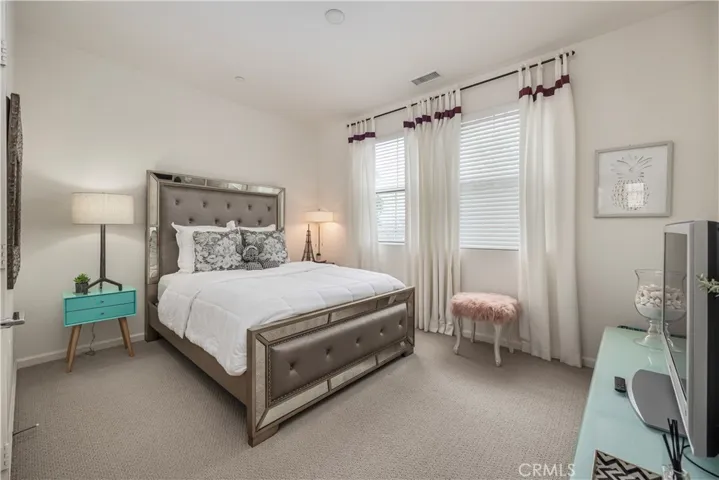 Bedroom two. Custom drapes and berber carpet.