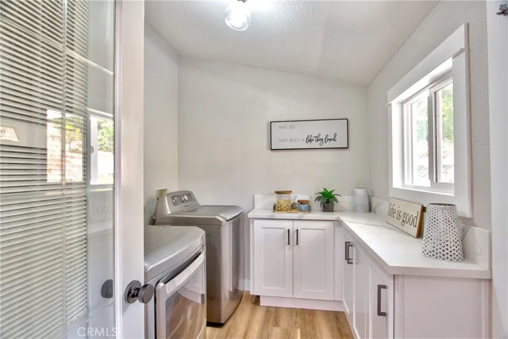 Individual Laundry Room with entrance from kitchen and back porch door.   Great for rainy day entrances.