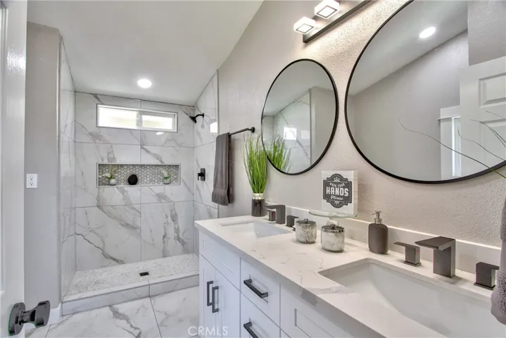 Primary bathroom with dual sinks and large shower