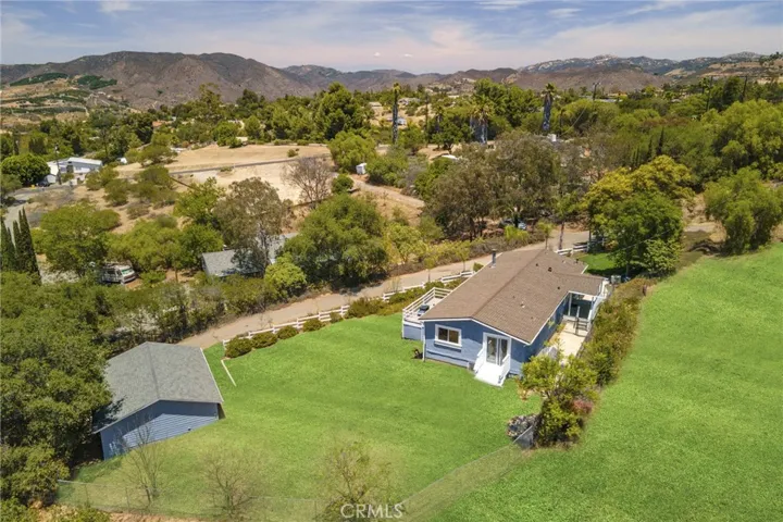 Aerial view showing 3 entries into the property.  Front, rear and side leading to a bedroom.  Lots of trees surrounding property making it very secluded.   Lots of privacy.