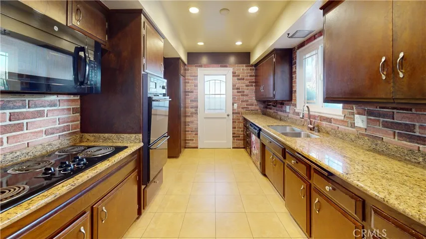 Kitchen w/granite counter tops, upgraded sink/faucet, appliances & recessed lighting.