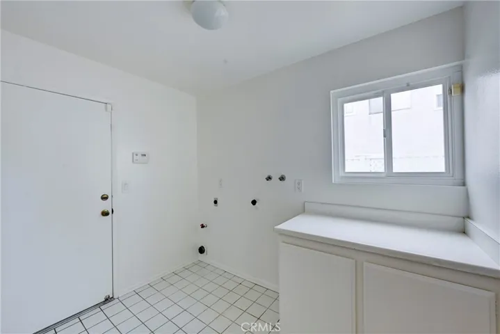Spacious laundry room with a window also has direct access to the garage.