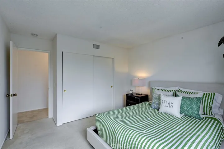 Bedroom #3 upstairs with large closet and soft carpet.