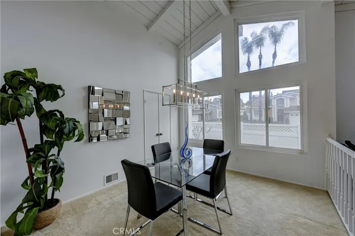 A wall of windows letting in lots of natural light in the formal dining room.