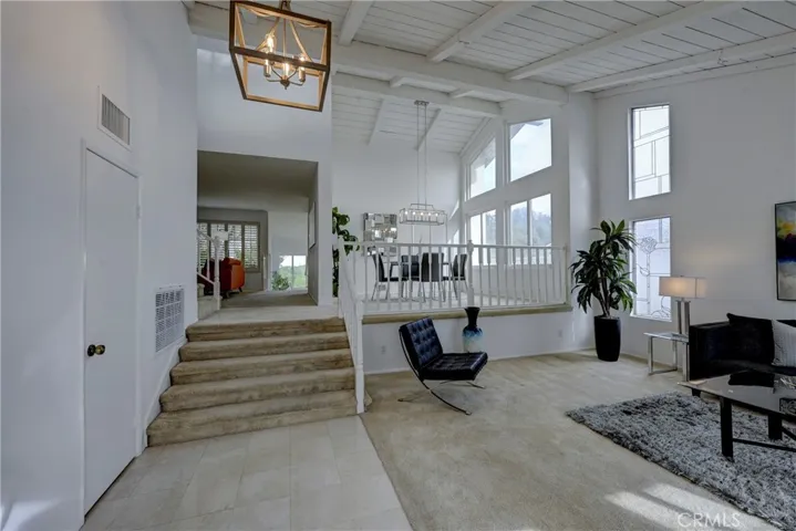 Vaulted wood beam ceilings in this formal living and dining room space.