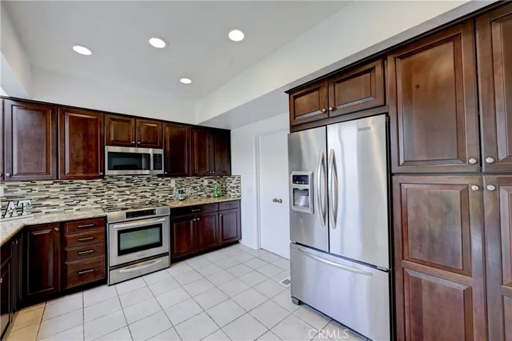 Stainless steel appliances and recessed lighting in this beautiful kitchen.