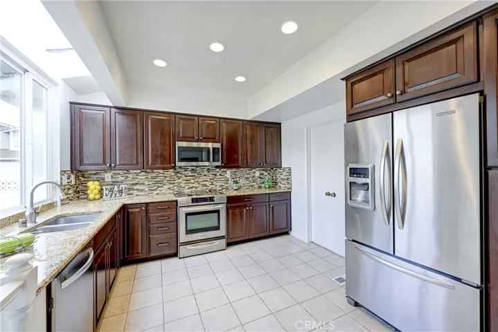 Overhead lighting and a large window over the double sink.