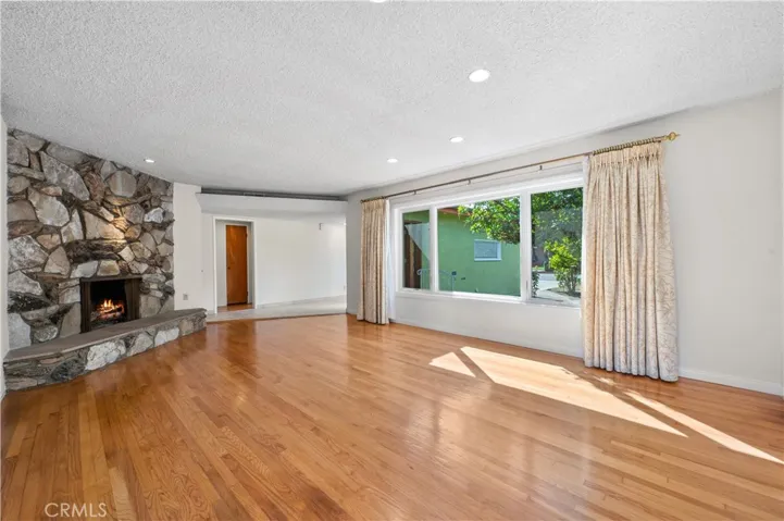 Spacious Living Room with Stone Fireplace