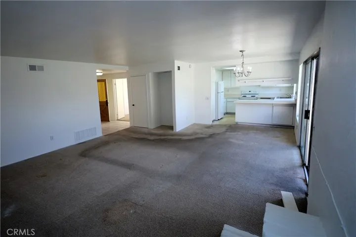 Living Room: Primary Bedroom at left, backyard at right.