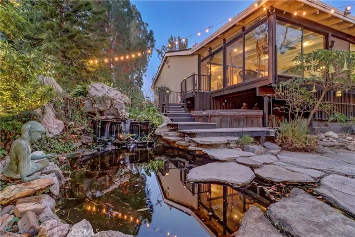 Southwest corner patio overlooking waterfall and koi pond