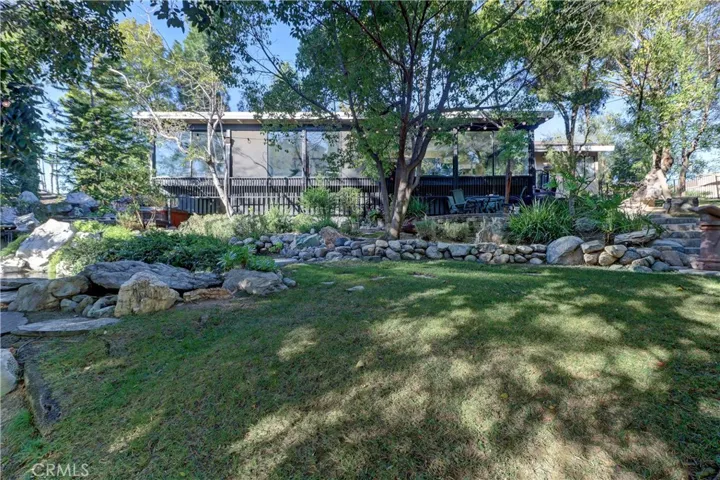 Looking from the lower yard up to the enclosed patio