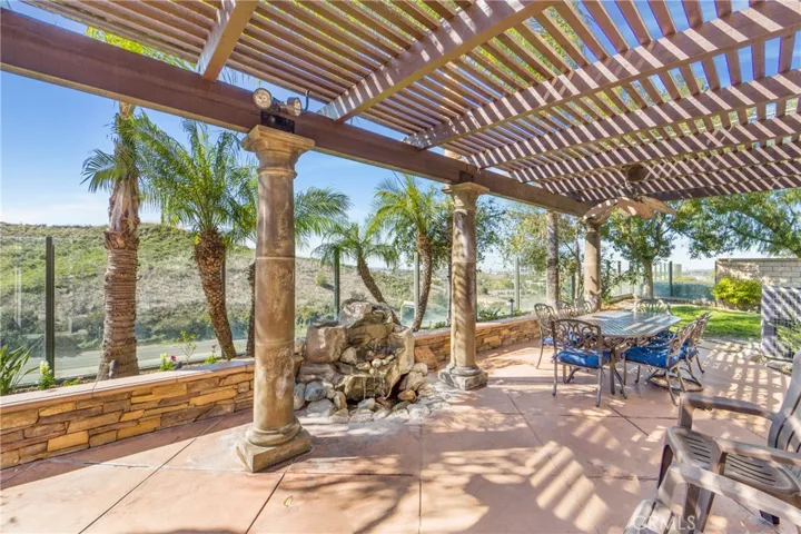 Full covered patio space and water feature.