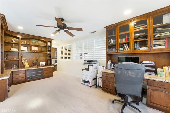 Expansive office, den, or sixth bedroom with custom built ins!