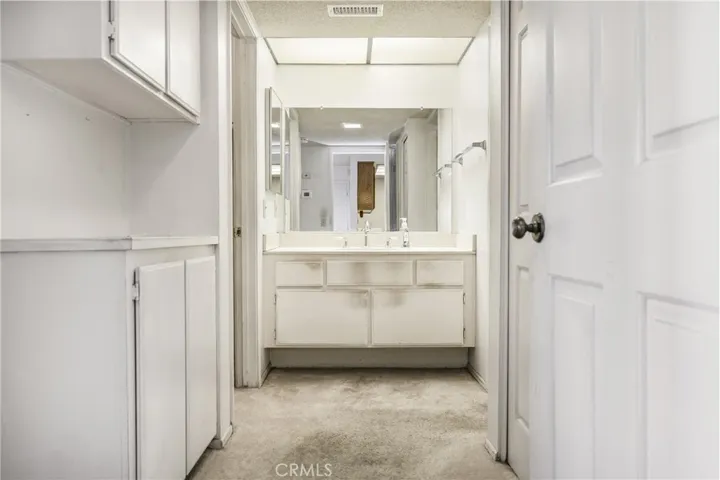 if the vanity were changed, there is a possibility of installing a double sink vanity. Private shower over tub and toilet room to the right of vanity.