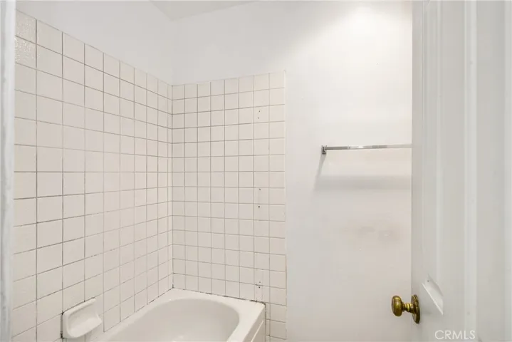 Closer view of the shower over tub area.