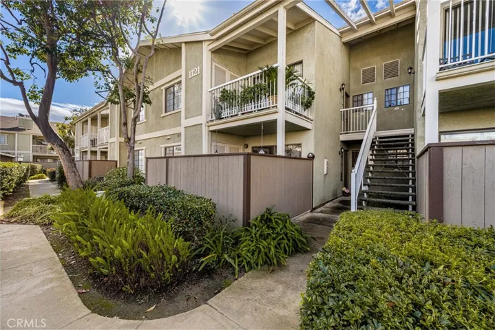 Looking at the same fence from the opposite side. Your front door is under cover and to the left of the stairway.