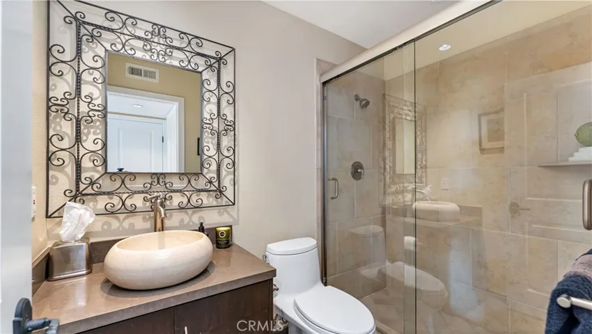 The Powder Room with such an attractive vessel sink and custom tile shower. Beautiful!