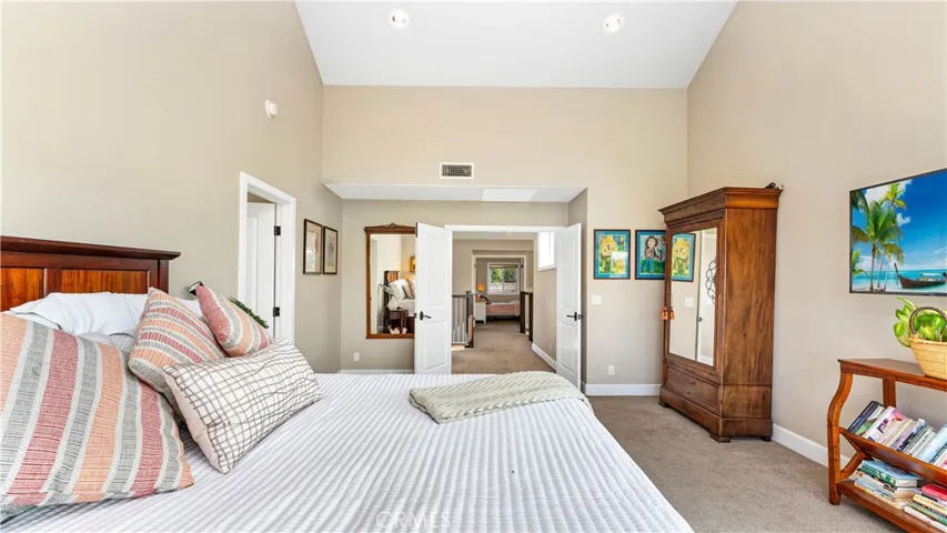 The Primary bedroom has double doors and custom  high ceilings