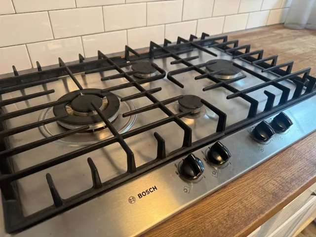 Boche propane cooktop with vent hood.