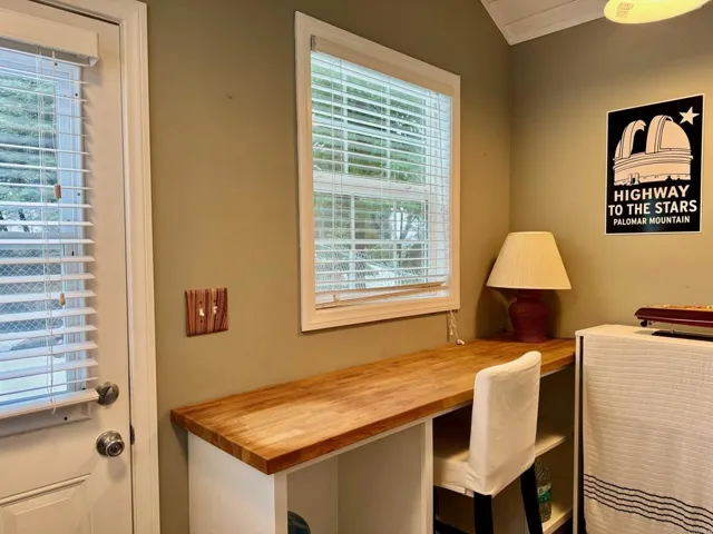 Walk in pantry with a desk looking out to the view.