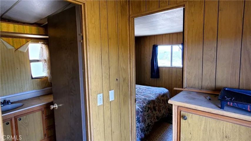 Just inside the door looking towards the back bedroom and the common bath in the mobile.