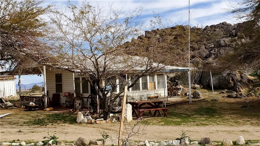Rec cabin with the rock outcrop to its eastside.