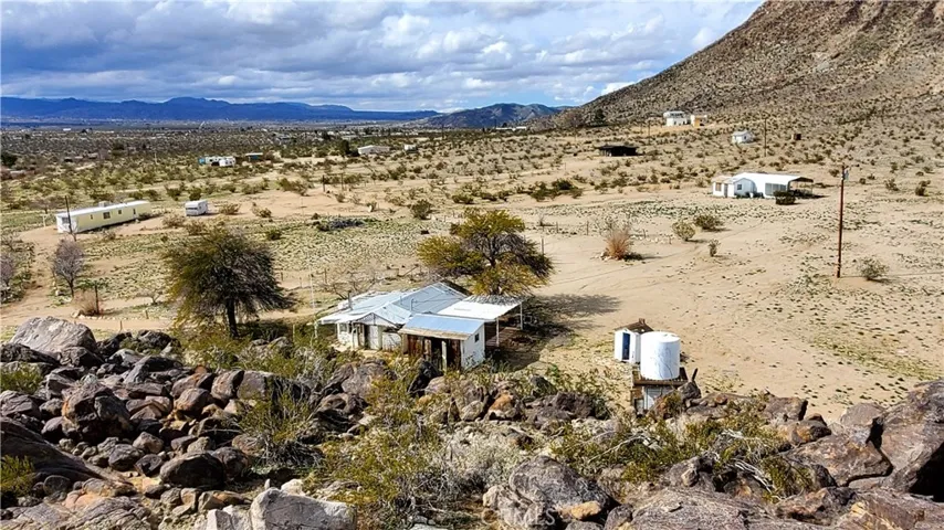 Pic from the rock outcrop looking northwest. Mobile on the left, rec cabin in the middle and homestead shop/carport on the right.